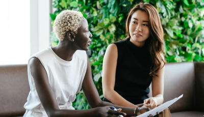 two ladies talking in a professional setting