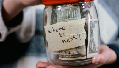 post-it note saying "where to next" on money jar
