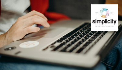 Someone typing on laptop with simplicity logo