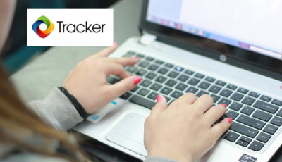 Hands typing on a laptop with Tracker logo